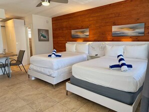 A hotel room with two beds, a desk, and a chair. - Comfortable Studio • 5-Min Walk to Beach #15 (Pompano Beach)