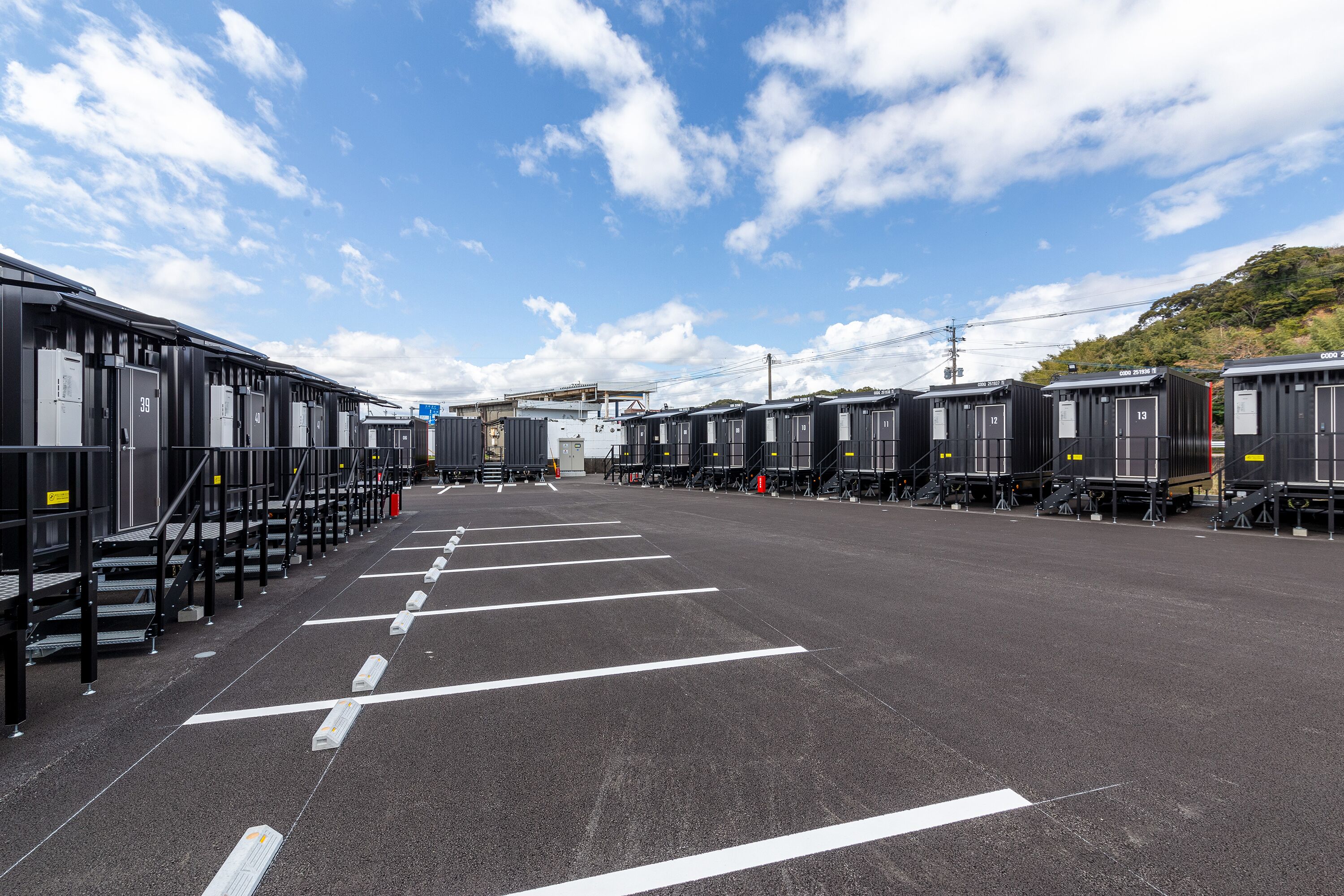 A parking lot with rows of parked trains and a clear sky.