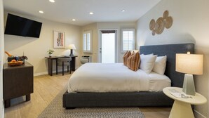 A modern hotel room with a large bed, a desk, a television, and a view of the outdoors. - The Mara Laguna Beach an AvantStay Hotel (Laguna Beach)