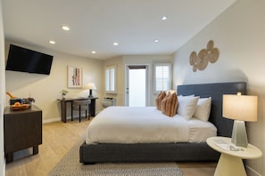 A modern hotel room with a large bed, a desk, a television, and a view of the outdoors. - The Mara Laguna Beach an AvantStay Hotel (Laguna Beach)