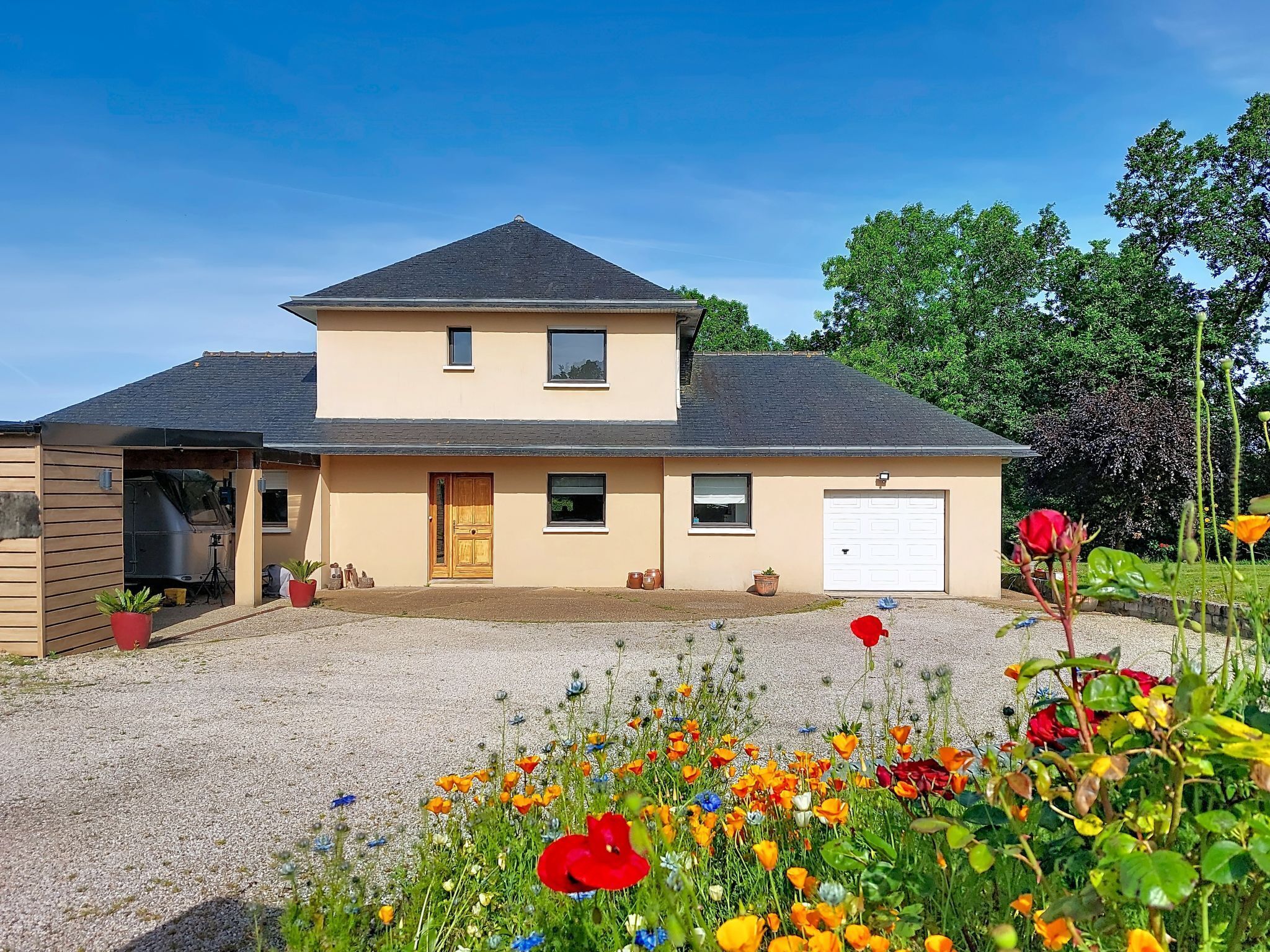 A two-story house with a garage, a front door, and a driveway.
