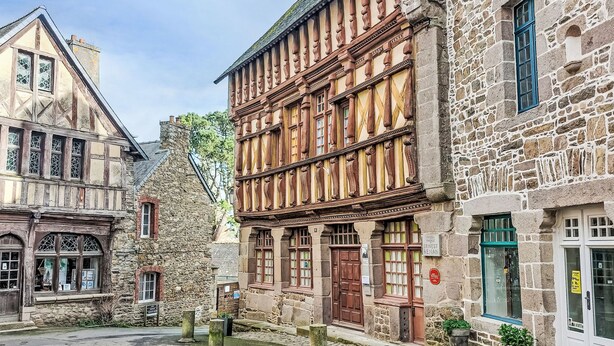 A historic stone building with a traditional timber-framed facade, a stone entrance, and a small courtyard. - La Chapelle by Interhome (Tréguier)