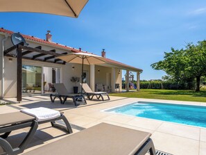 A poolside area with lounge chairs, a covered patio, and a children's play structure. - Vacation home Lapis by Interhome (Poreč/Sv. Lovreč)