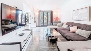 A modern living room with a sofa, coffee table, and TV. - La Sorba by Interhome (Saint Cyr sur mer Les Lecques)
