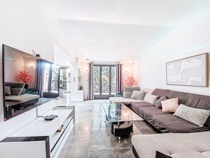A modern living room with a sofa, coffee table, and TV. - La Sorba by Interhome (Saint Cyr sur mer Les Lecques)