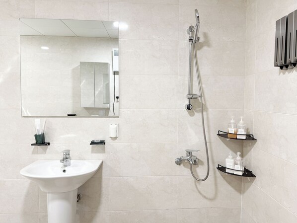 A bathroom with a sink, mirror, shower, and shelves with toiletries. - OVER THE MOUNTAIN (Gapyeong)