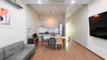 A modern apartment with a living room, dining area, and kitchen.