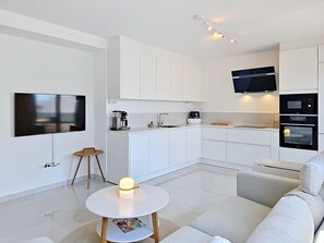 A modern kitchen with white cabinets, a coffee maker, a microwave, and an oven. - Sunny Terrace by Interhome (Trogir/Okrug Gornji)