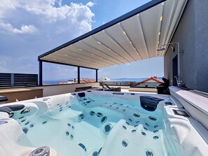 A rooftop terrace with a hot tub, outdoor seating, and a view of the sea. - Sunny Terrace II by Interhome (Trogir/Okrug Gornji)