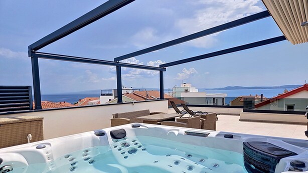 A rooftop with a hot tub, wicker furniture, and a view of the sea. - Sunny Terrace II by Interhome (Trogir/Okrug Gornji)