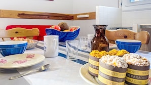 A dining table with bowls, a pitcher, and a plate with food items. - Maison Erdeven by Interhome (Erdeven)
