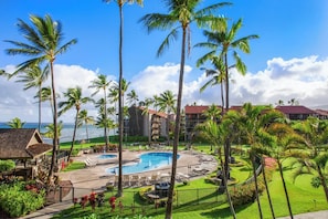 A resort with a pool, palm trees, and ocean views. - Papakea Villas | Ocean View Studio Sleeps 4 | Car Incl. w/ 6+ Nights | PKD-303 by KBM (Lahaina)