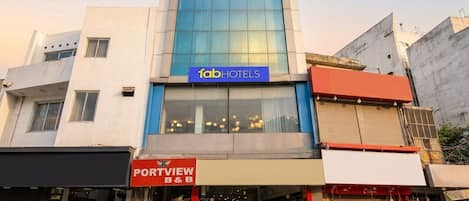 A building with a sign for 'fabHOTELS' and a storefront for 'PORTVIEW B&B'.