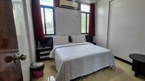 A hotel room with a bed, a small table, a TV, and a window. - Fabhotel Atithi Executive (Pune)