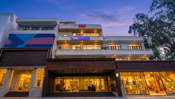 A multi-story building with a sign for 'Fabi Hotels' and a large glass storefront. - Fabhotel Park View (New Delhi)