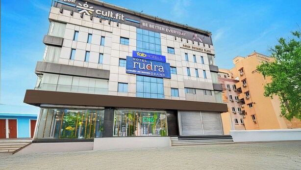 A building with a fitness center, a hotel, and luxury rooms. - Fabhotel Rudra Grand (Hyderabad)
