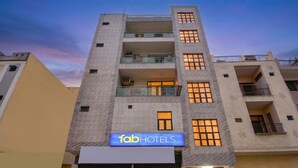 A multi-story building with a sign for 'fab hotels' indicating a hotel presence. - Fabhotel Mb Residency (New Delhi)