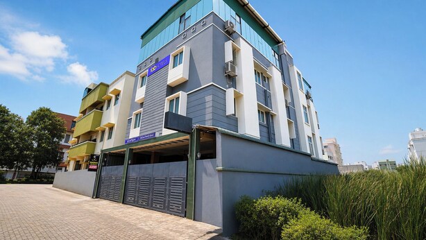 A multi-story hotel with a modern design, featuring a prominent 'Fab Hotels' sign. - Fabhotel Madras Residency (Chennai)