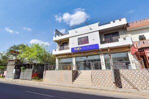 A two-story building with a sign for 'Fab Hotels' and a restaurant. - Fabhotel Hans (Jaipur)
