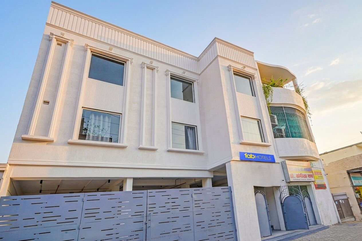 A modern hotel with a flat facade, large windows, and a sign for 'fabHOTELS'.