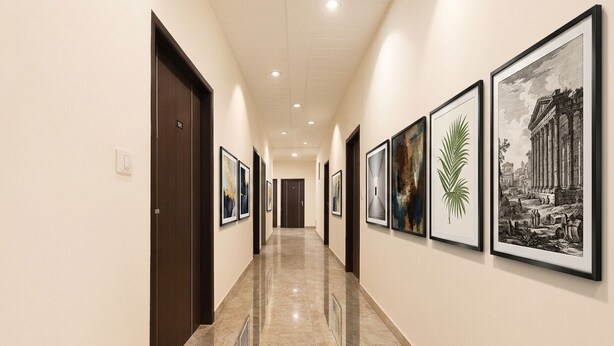 A hallway with framed artwork on the walls and a marble floor. - Fabhotel Madhuban (Jaipur)