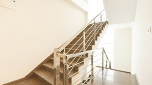 A staircase with metal railings and granite steps, leading to a higher floor. - Fabhotel Madhuban (Jaipur)