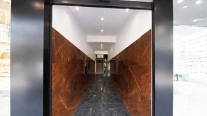 A modern interior with a marble floor and a glass door leading to a staircase. - Fabhotel Destiny Living (Pune)