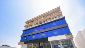 A multi-story hotel with a prominent 'fab hotels' sign, large glass windows, and a modern architectural design. - Fabhotel Destiny Living (Pune)