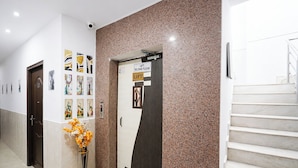 A hallway with a door marked 'LIFT SECOND FLOOR' and a staircase. - Fabhotel The Max (Lucknow)