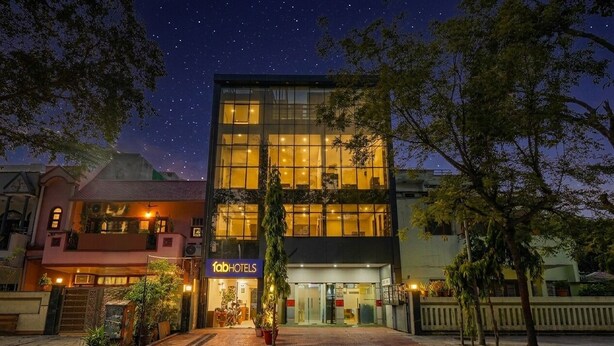 A modern hotel with a glass facade, a visible entrance, and a signboard. - Fabhotel Celebrity Inn (New Delhi)
