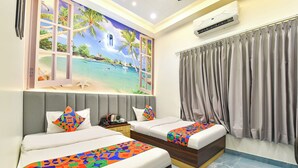 A hotel room with two beds, a large window with curtains, an air conditioning unit, and a mural of a beach scene. - Fabhotel The Nine Prime (Jaipur)