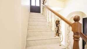 A marble staircase with ornate balusters and a wooden handrail. - FabHotel Triple Beach House - Nr. Benaulim Beach (Morjim)