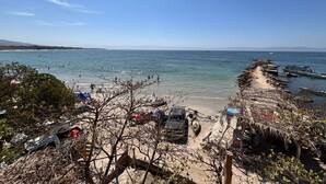 A beach with boats, a sandy path, and some vegetation. - Amaizing View Islas Marietas (Punta de Mita)