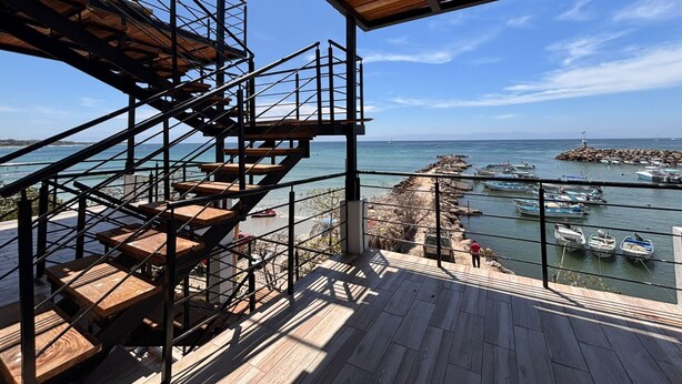 A wooden staircase leading to a balcony overlooking a marina with boats. - Amaizing View Islas Marietas (Punta de Mita)