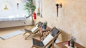 A room with a bed, a small table with chairs, a wall-mounted lamp, and a potted plant. - Landhaus Bergkristall by Interhome (Dalaas)