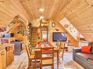 A wooden interior with a dining area, kitchen, and living space.