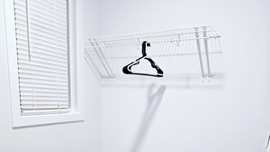 A room with a white wall, a window with blinds, a white carpet, and a metal drying rack. - Room-private Master Bed & Bath #1 Cautle (Edmonton)