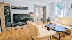 A living room with a TV, sofa, and coffee table. - Fewo Römerweg by Interhome (Neustadt an der Weinstraße)