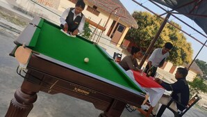 A pool table with a white ball, surrounded by people. - Elephant Garden Hotel and Resort (Kanchanrup)