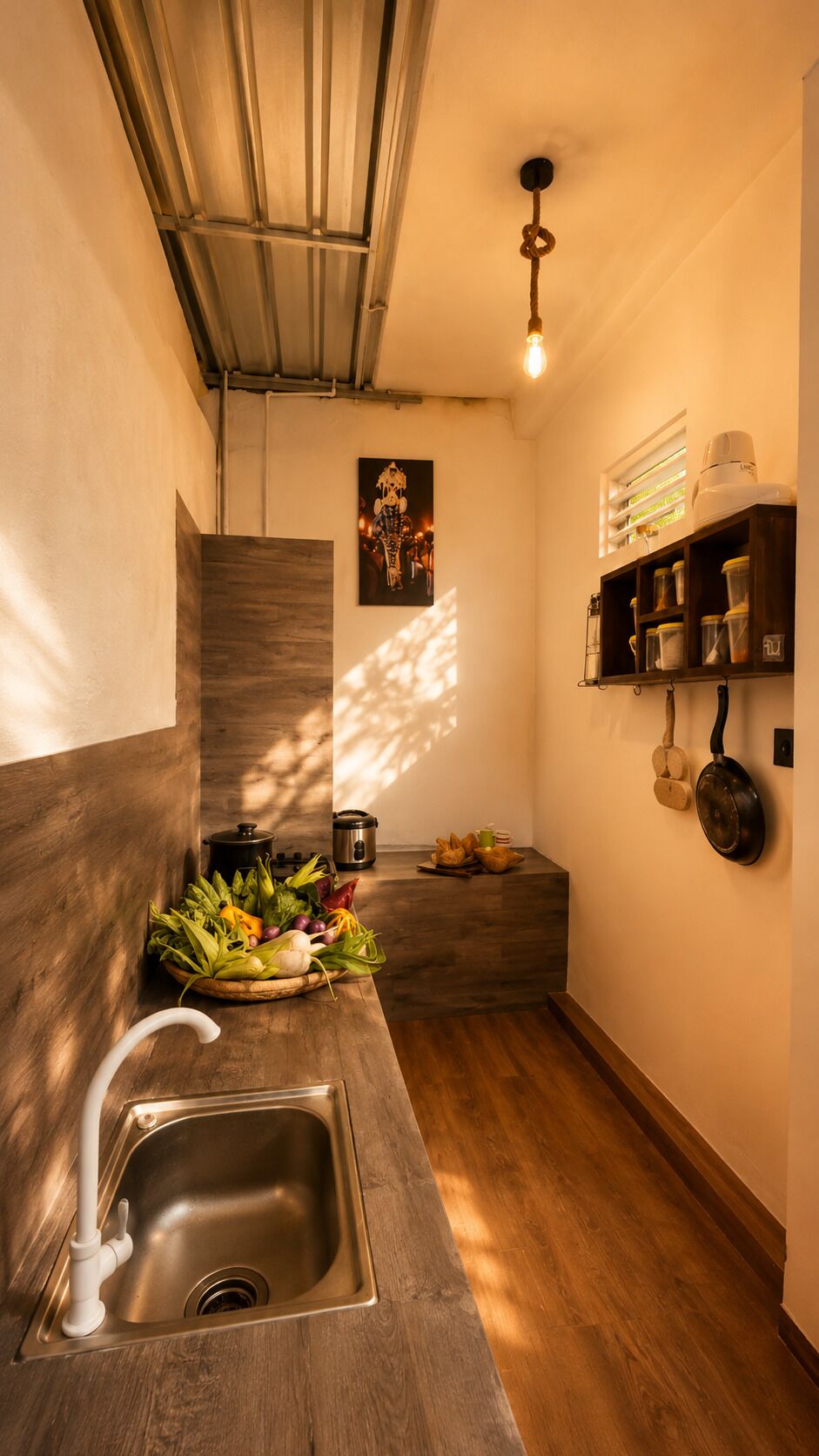 A kitchen with a wooden countertop, a stainless steel sink, and a hanging pot rack.