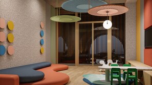 A modern interior with a seating area, a table with chairs, and a large window with vertical blinds.