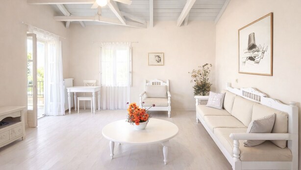 A spacious living room with a white ceiling fan, a white sofa, a white table, and a white chair. - Gaea Pylos: Spacious family house near beaches (Pylos Nestoros)
