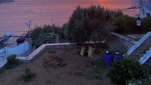 A sunset view over the sea with a building and a tree in the foreground. - Kalymnos getaway atop Linaria Beach (Kalimnos)