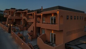 A multi-story building with a unique architectural design, featuring balconies, staircases, and a courtyard.