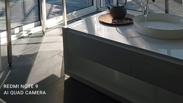 A modern room with large windows, a glass table, and a view of greenery outside. - AGATHOISE MAS at CAP D'AGDE (Agde)