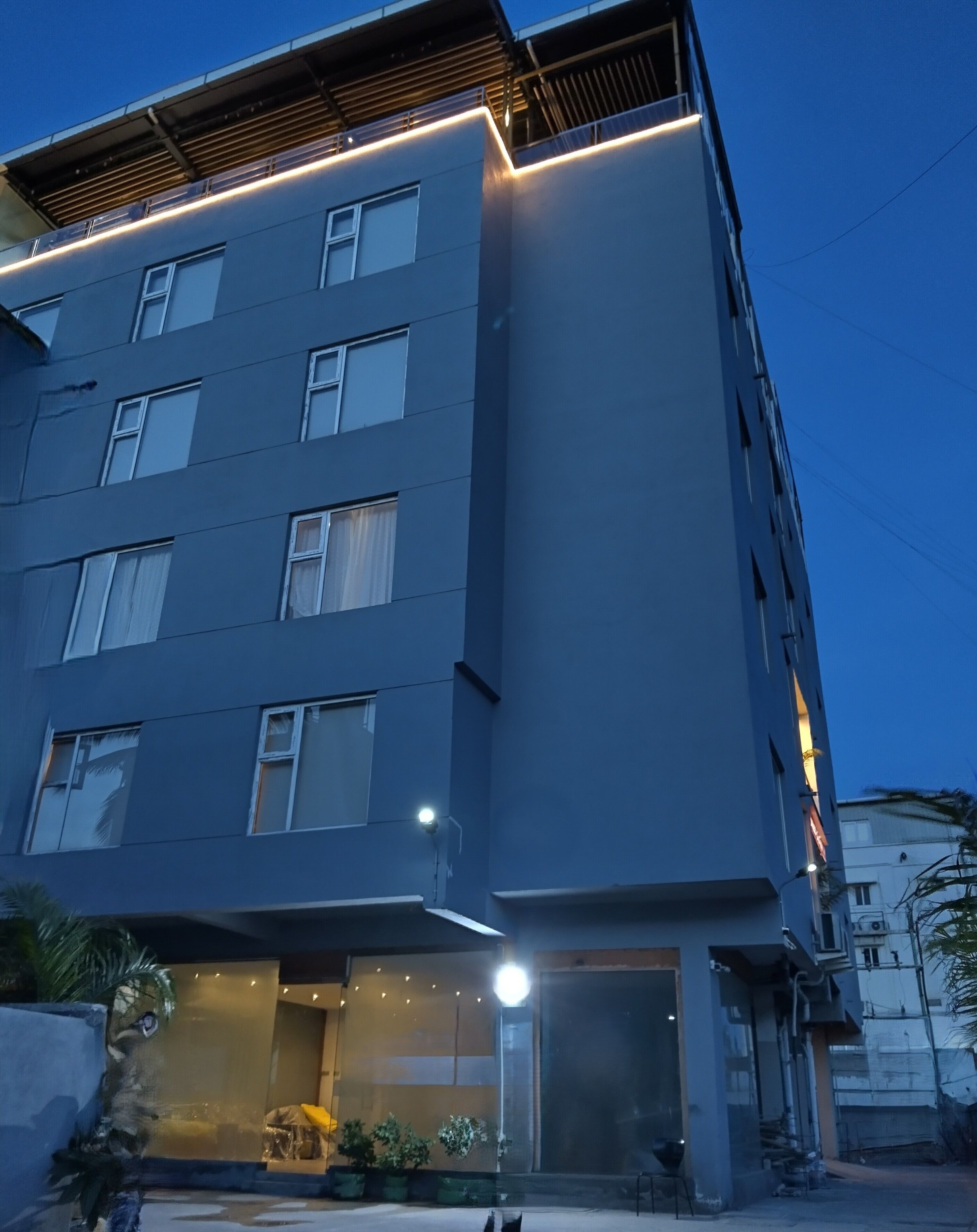 A multi-story building with a modern design, featuring large windows and a flat facade.