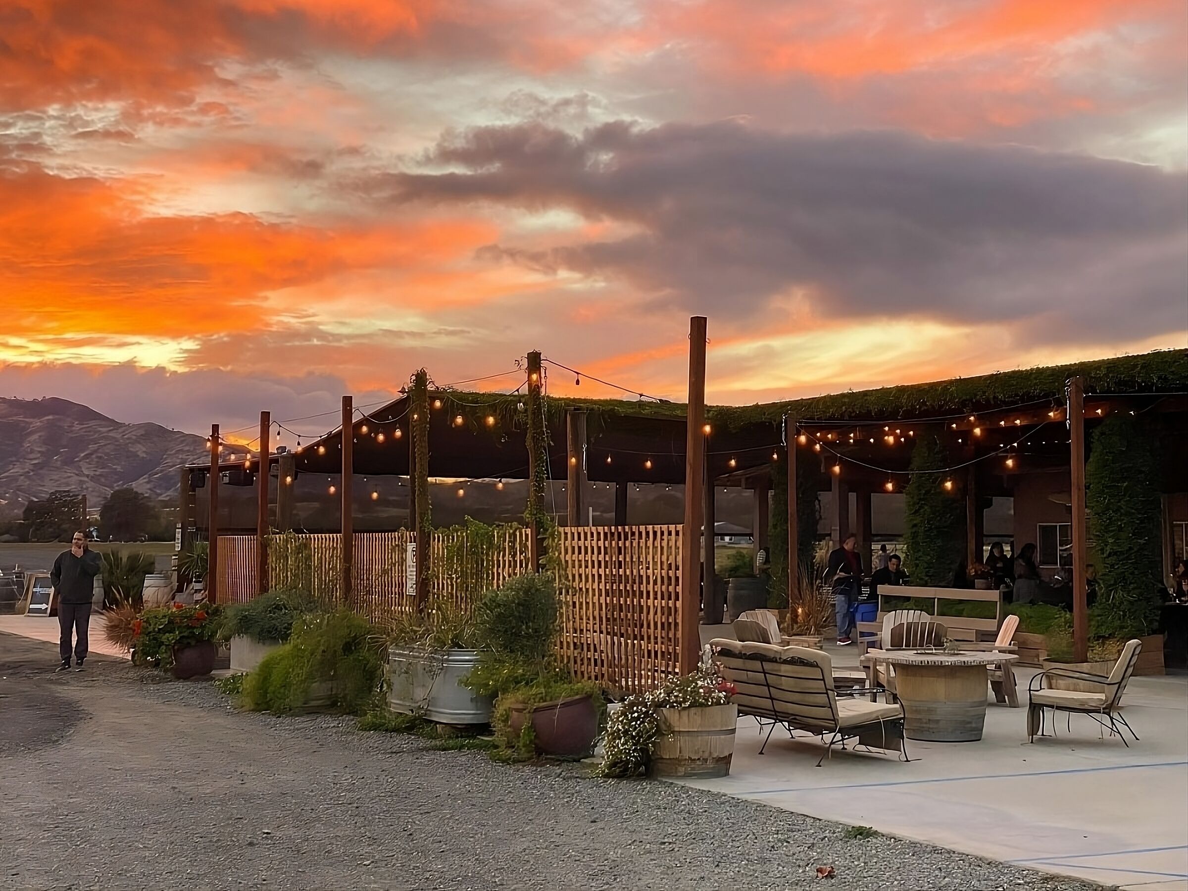 Unwind under glowing string lights as sunset colors the sky.