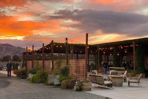 Unwind under glowing string lights as sunset colors the sky.