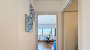 A hallway leading to a dining area with a view of the cityscape. - Soley with parking by Interhome (De Haan)