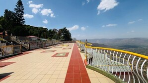 A pathway with railings, leading to a scenic overlook.